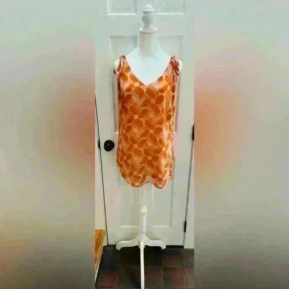 Cabi size M sleeveless top, ties at the shoulders, has 2 layers, orange & cream.